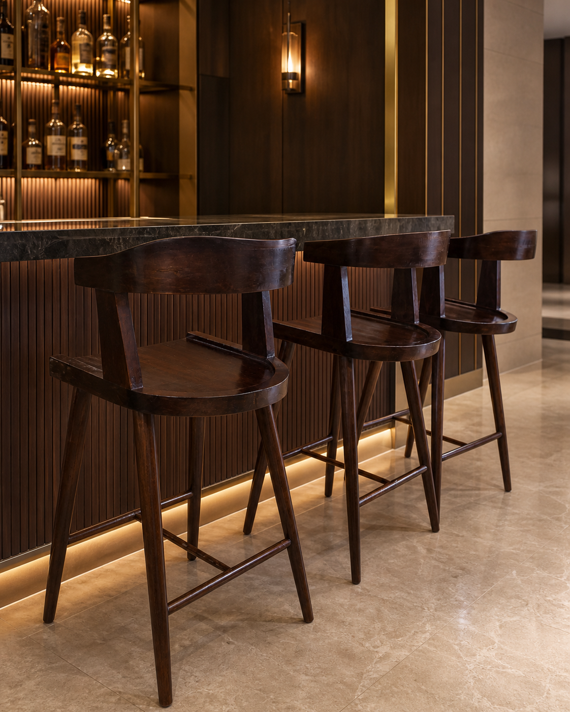 Three handcrafted Heritage Mahogany Counter Chairs arranged at an elegant walnut hotel bar